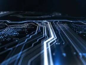 Close-up view of an illuminated circuit board with intricate blue and white lines representing electronic pathways on a dark background.
