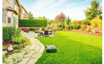 Lush green backyard with manicured lawn, stone path, cozy seating area, and vibrant flower beds under a bright blue sky.