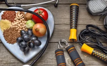 A heart-shaped plate filled with healthy foods, surrounded by a stethoscope, workout grips, and running shoes on a wooden surface.