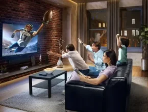 A family cheers excitedly while watching a football game on TV in a cozy living room, with snacks on the coffee table.