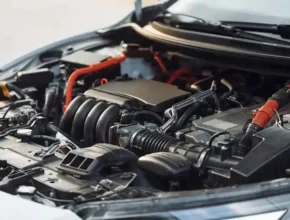 Close-up of a modern car engine, showcasing intricate components, wiring, and a sleek design under the hood.