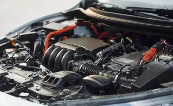 Close-up of a modern car engine, showcasing intricate components, wiring, and a sleek design under the hood.